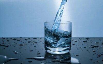 High-quality image of water being poured into a glass, illustrating hydration and purity.