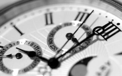 Detailed black and white shot of an elegant watch face showcasing timekeeping elements.